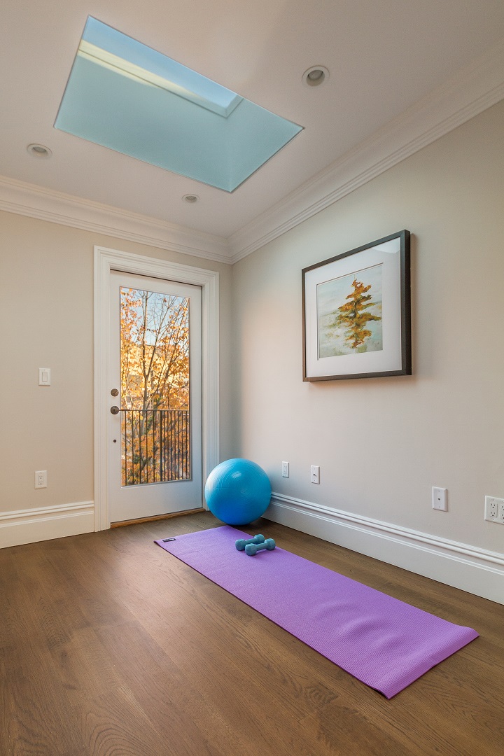 Image of the interiors of a room with a yoga mat in it